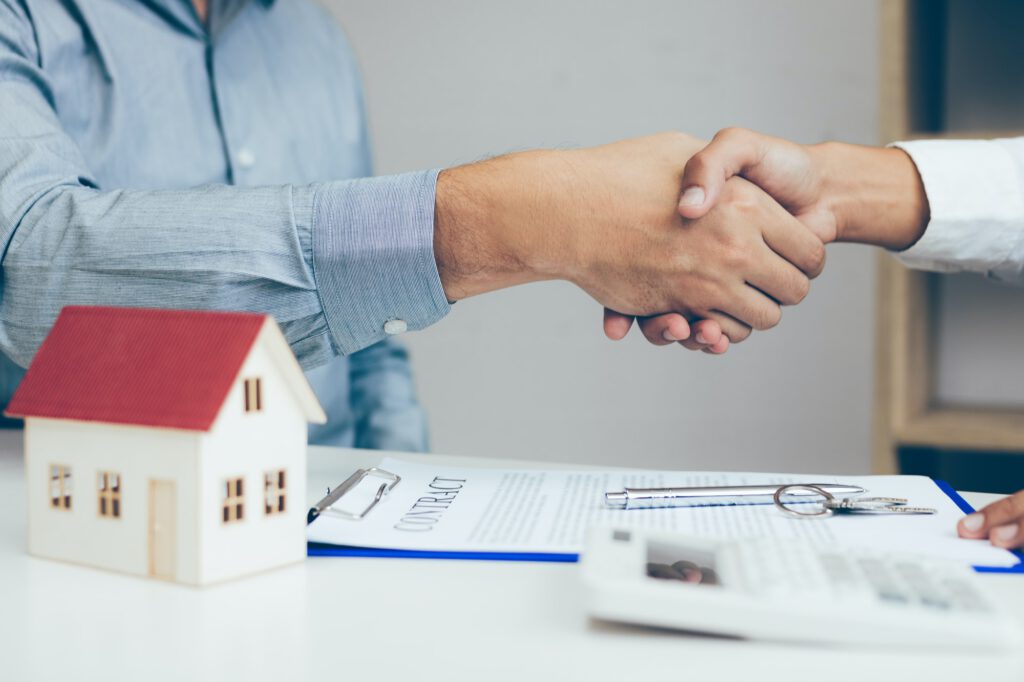 Close up of shaking hands with customer and real estate broker after