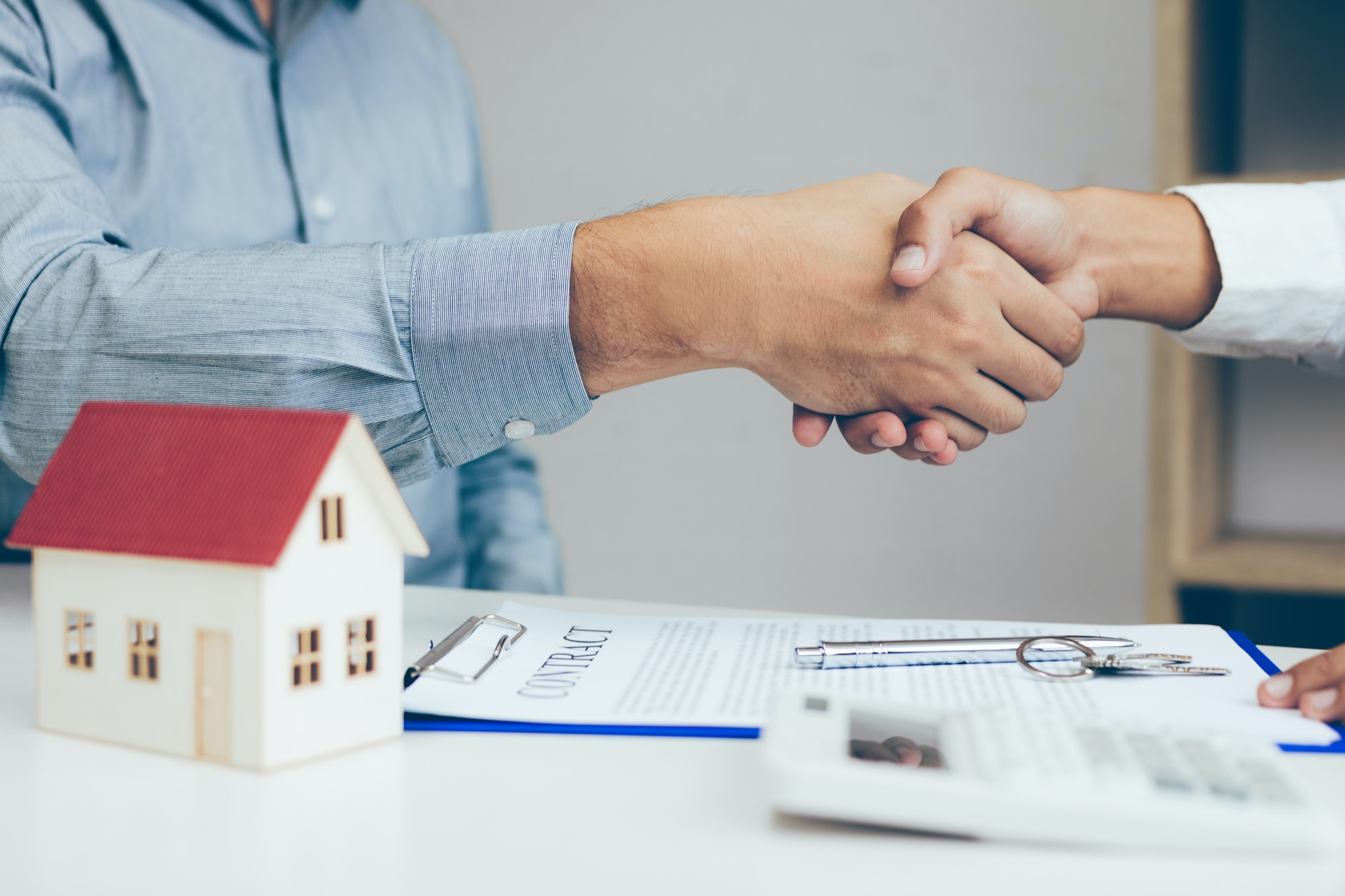 Close up of shaking hands with customer and real estate broker after