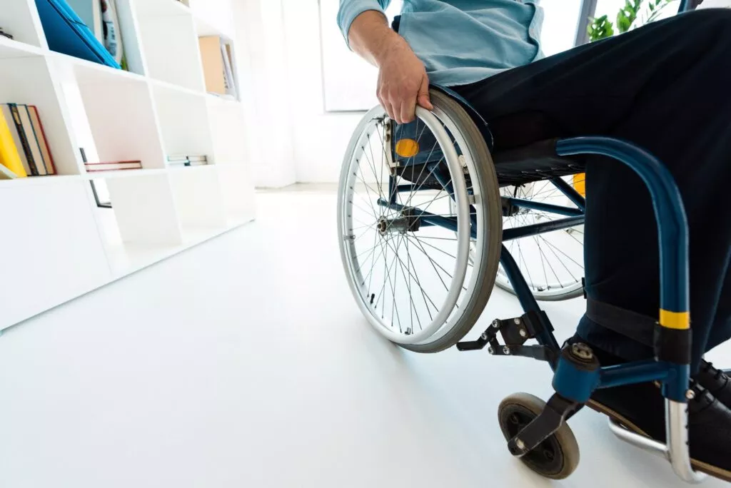 physically handicapped businessman sitting in wheelchair at office