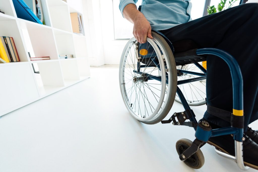 physically handicapped businessman sitting in wheelchair at office